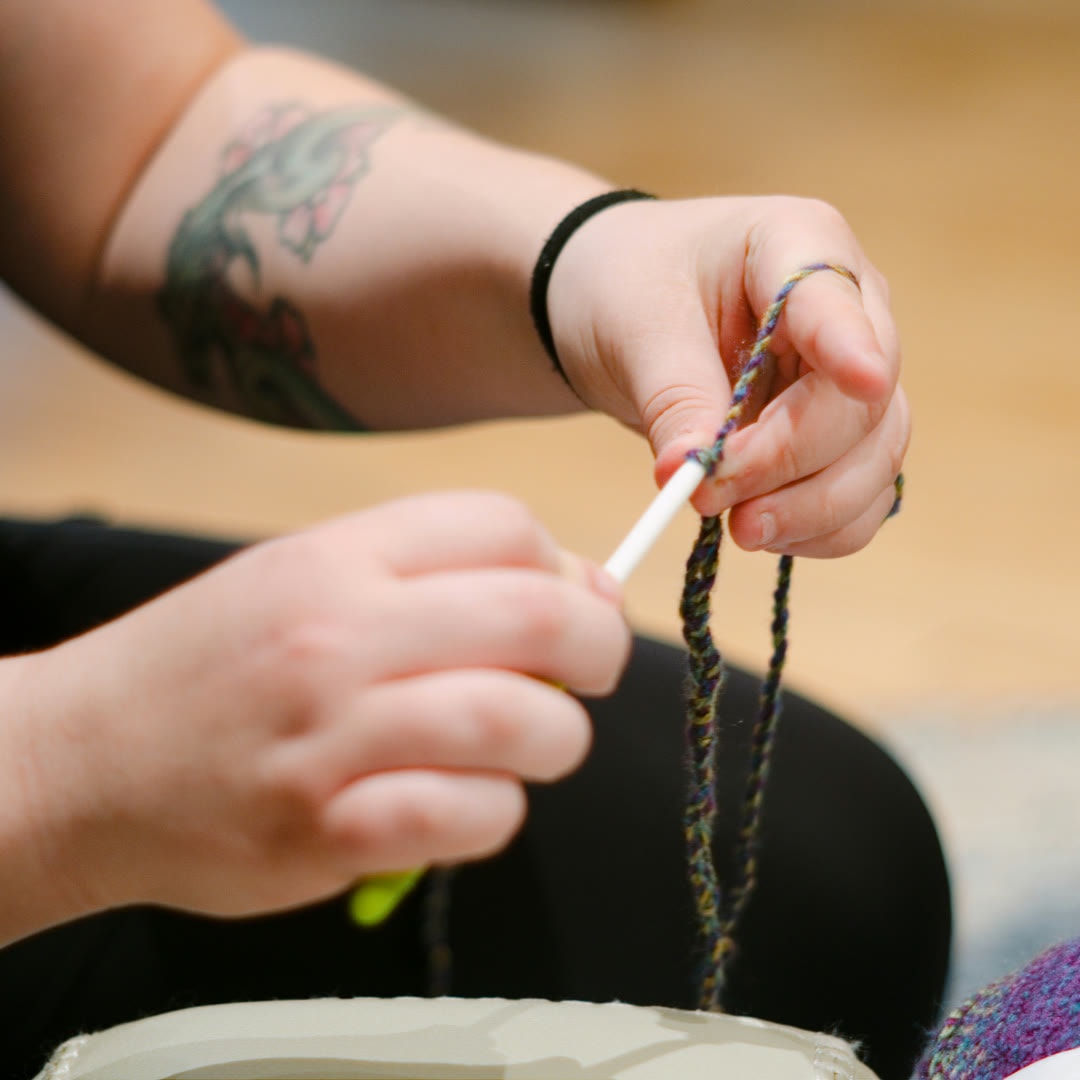 Close-up of hands braiding cord
